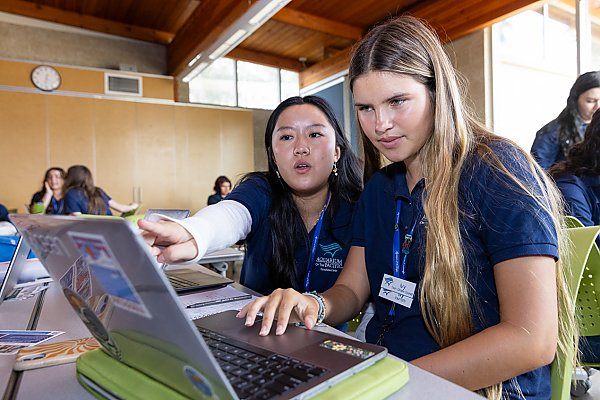 educator pointing to laptop